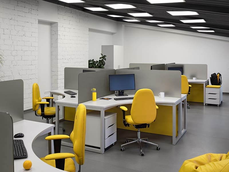 office with yellow chairs and desks
